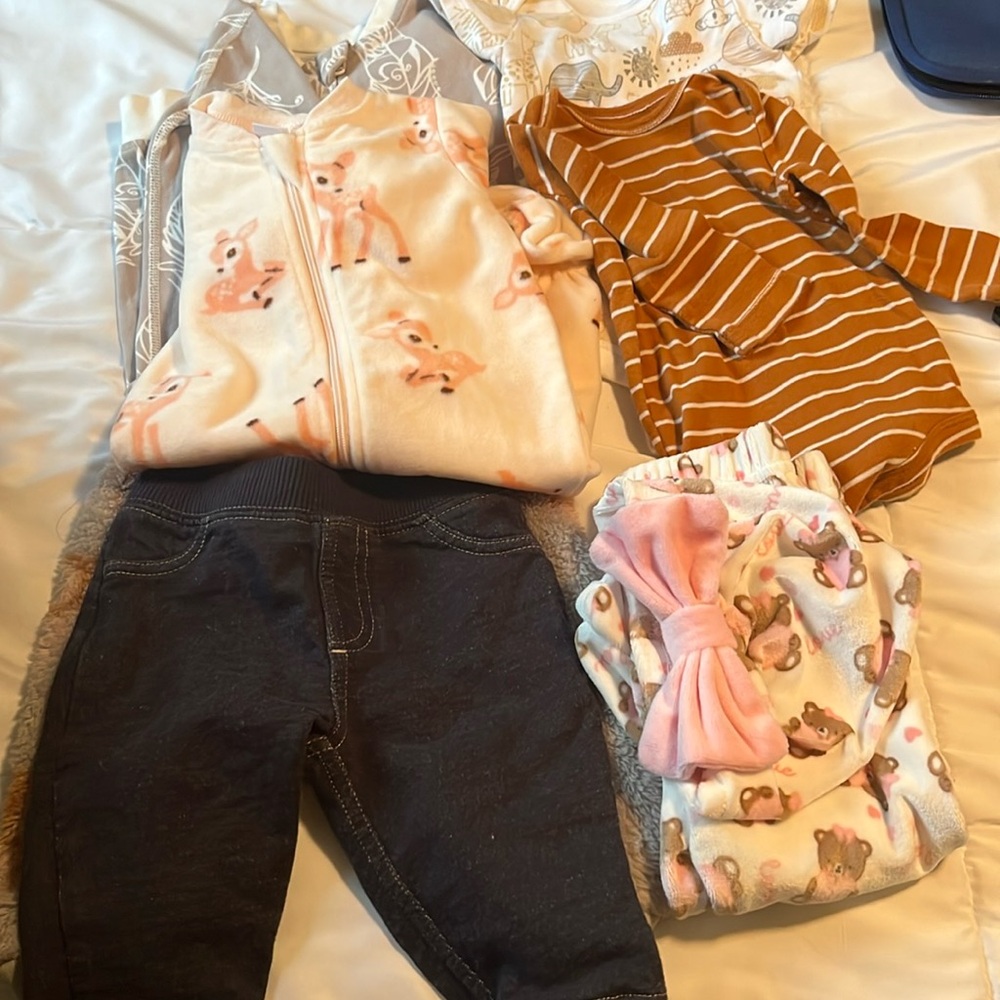 Bundle of babies clothes. Pants, hat,onesie, sleep wear.